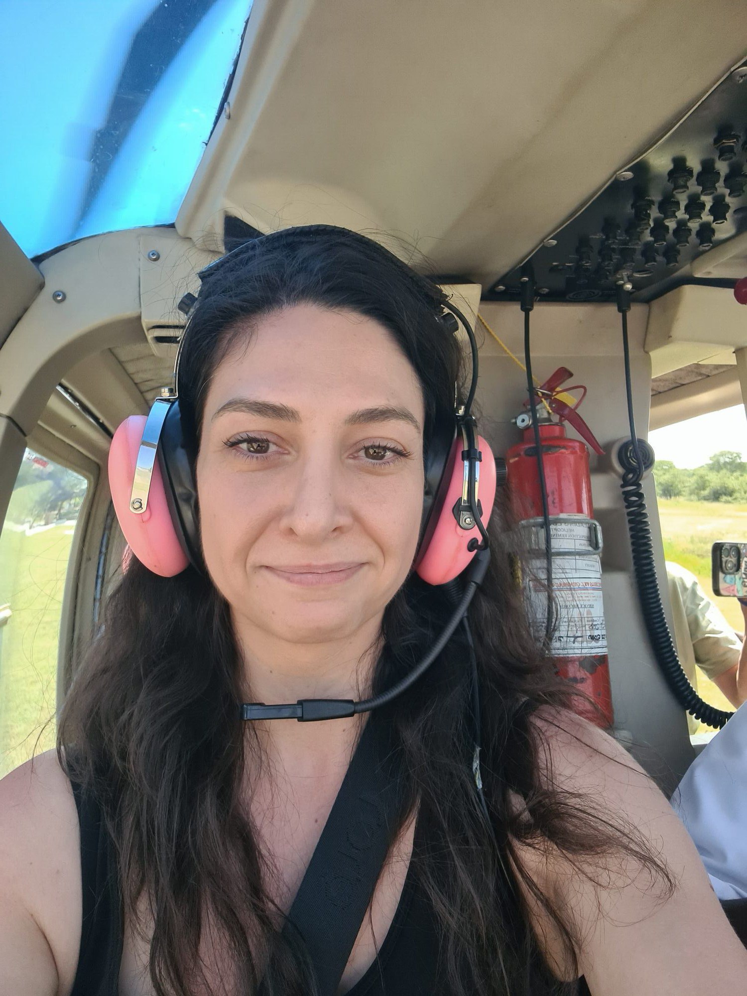 Kelly in the cockpit of a helicopter over Victoria Falls, Zambia